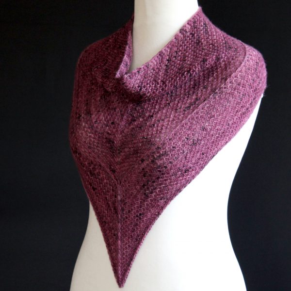 A cowlette knit in purple yarn with two brioche patterns and two slipped stitch bands