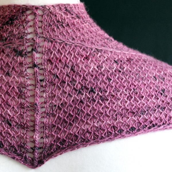 The back of a cowlette knit in purple yarn with two brioche patterns and two slipped stitch bands